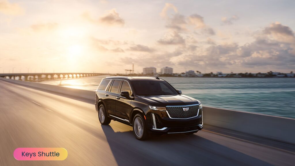 Luxury SUV driving along the Overseas Highway in the Florida Keys at sunset, with golden light reflecting on the water and bridges in the background, showcasing premium private car service.