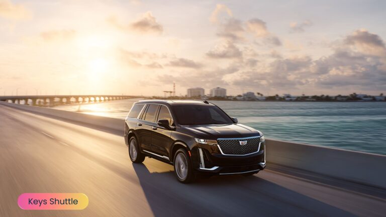 Luxury SUV driving along the Overseas Highway in the Florida Keys at sunset, with golden light reflecting on the water and bridges in the background, showcasing premium private car service.